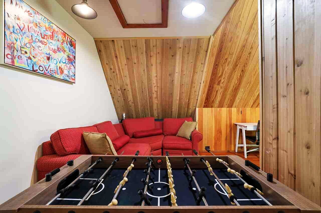 The home theatre with tiered red seating.