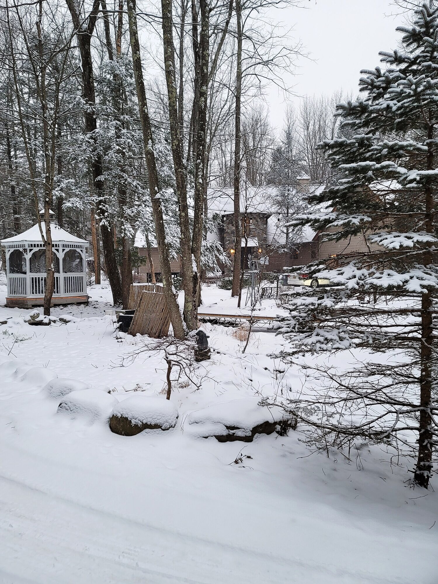 The grounds under snow: the gazebo and pond in deep winter.